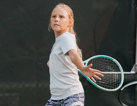Girl returning tennis ball