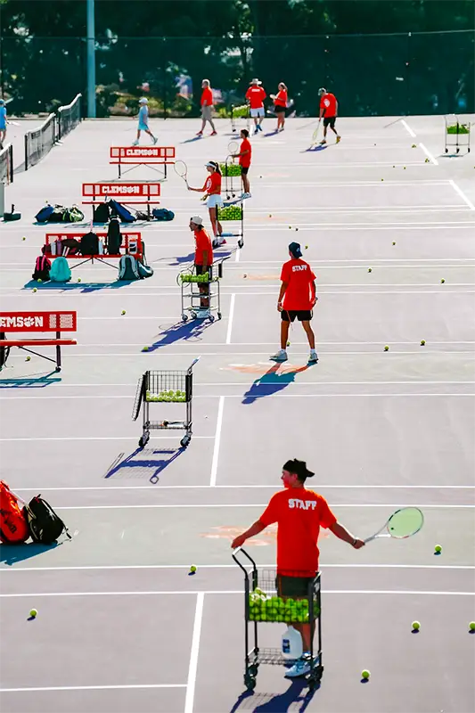 Arial shot of players hitting balls to kids